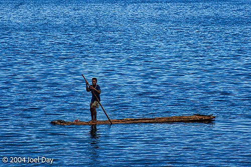 Man Paddling Handmade Raft on Sea along Ovalau Island, Fiji