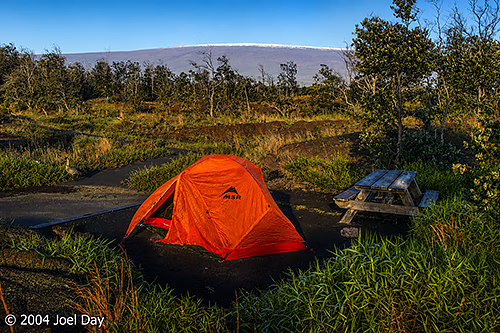 Camping in the shadow of the snow-capped Mauna Loa Volcano in Hawai'i Volcanoes National Park, Island of Hawai'i, Hawai'i
