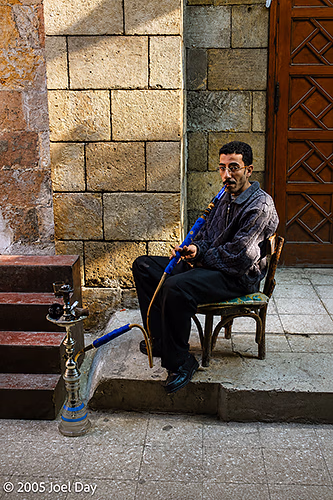 Egyptian man smoking hookah in Khan el-Khalili, a famous bazaar in the historic centre of Cairo, Egypt