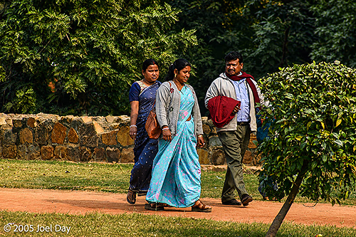 Visitors to the Monuments and Buildings of the Qutb Minar complex (finished in 1368), Delhi, India
