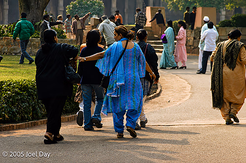 Visitors to the Monuments and Buildings of the Qutb Minar complex (finished in 1368), Delhi, India