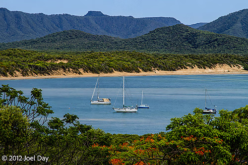 Boats moored on the Endeavour River flowing past Cooktown, Queensland